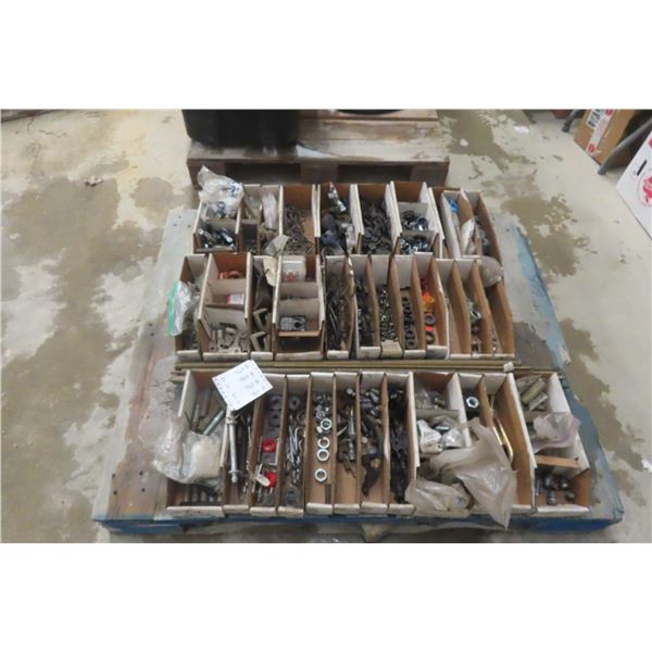 Pallet Lot Including Trailer Hitch Plug, Nuts and Bolts, Clamps, Rebar and Battery Terminal.