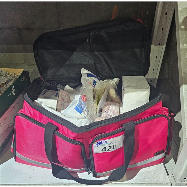 LARGE RED DUFFLE BAG OF ASSORTED FIRST AID: BANDAGES, PRESSURE DRESSING, TENSOR BANDAGES & MORE