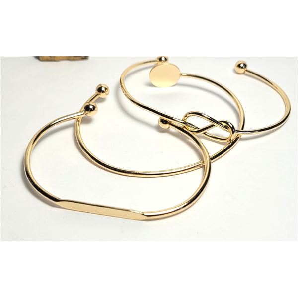 20)  LOT OF 3 GOLD TONE OPEN ENDED BANGLE