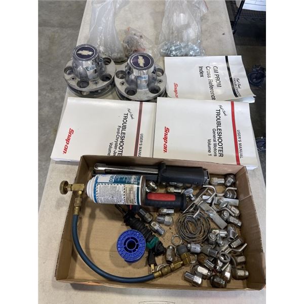 TRAY OF ASSORTED AUTOMOTIVE ITEMS INCLUDING CHEVY CAPS, AND GM MAINTENANCE BOOKS