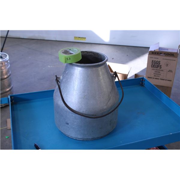 Galvanized metal milk can featuring a classic design with a single metal handle for carrying.