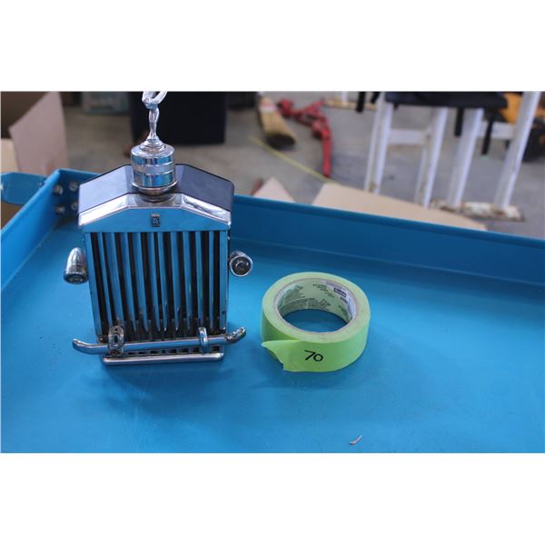 A unique car-shaped decanter with a built-in music box, featuring a chrome finish and designed to re