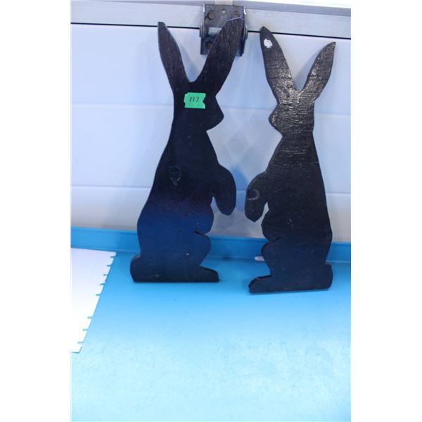Wooden rabbit silhouettes painted black.