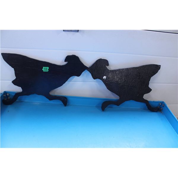 Black-painted woode bird silhouettes depicting running or leaping birds