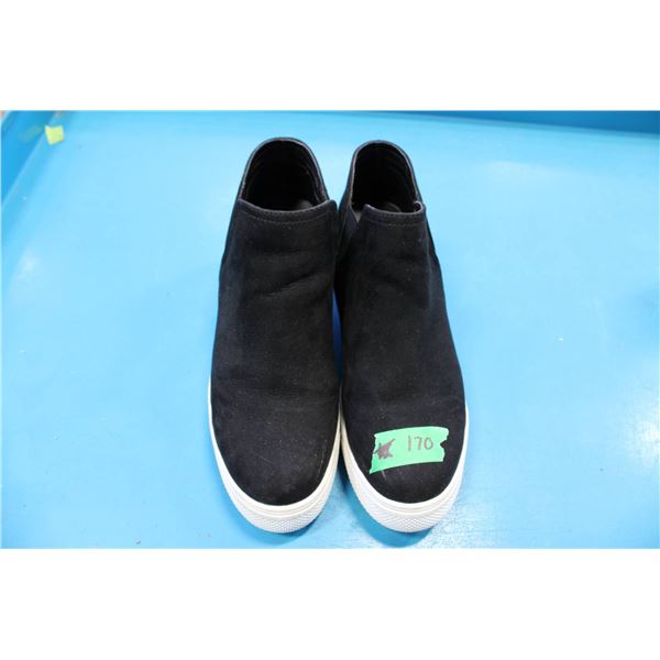 Steve Madden black slip-on sneakers featuring a suede-like finish and a white rubber sole