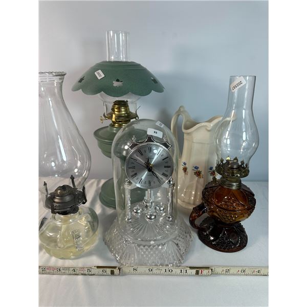 Group lot featuring a clear glass dome quartz clock with Roman numeral dial, accompanied by assorted