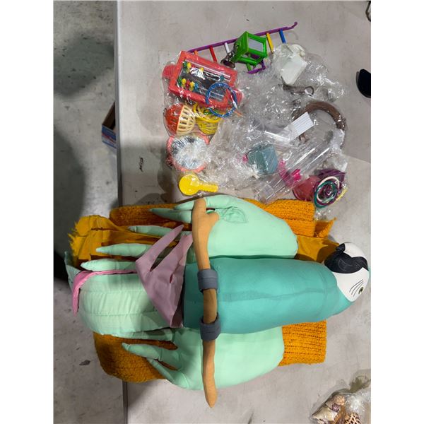 Birdcage toys, parrot, and blanket