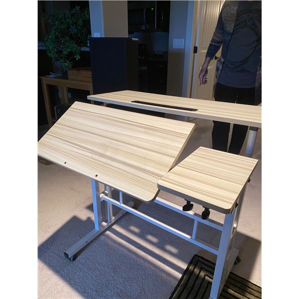 Desk/craft elevates  from 30 to 48 inches, on wheels 31 1/2 in wide 23 1/2 in deep
