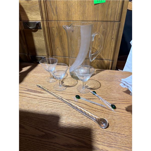 Glass pitcher and sticks and glasses