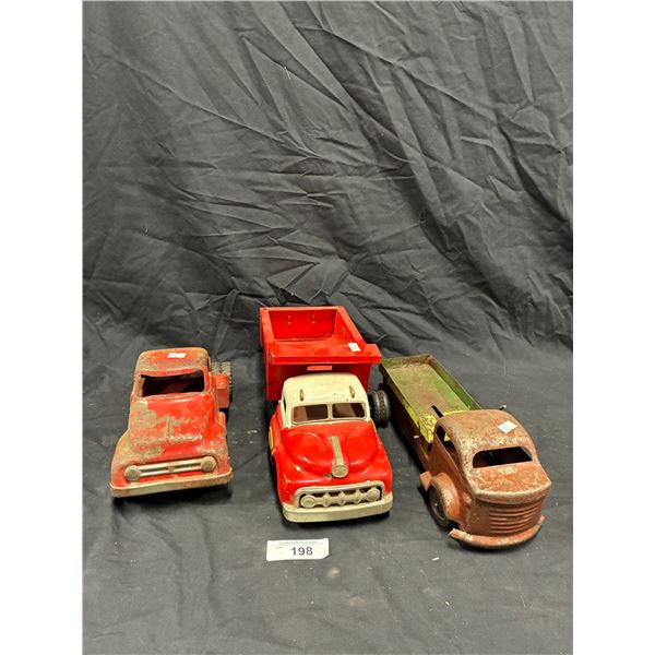 3 vintage pressed steel trucks as shown, inc GMC, one missing wheel, longest 14"