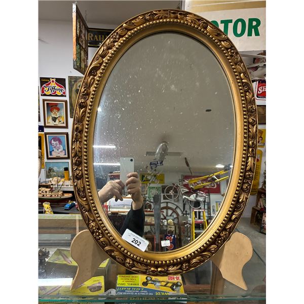 Ornately framed oval mirror 27" tall