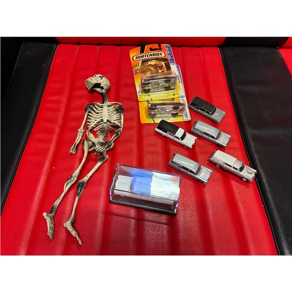 Collection of die cast hearses (8) and rubber skeleton missing hand