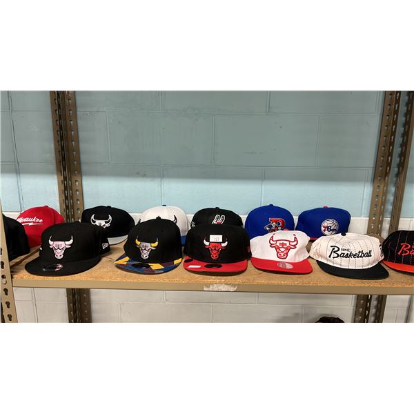 SHELF OF ASSORTED HATS INCLUDING; CHICAGO BULLS, PHILADELPHIA 76ERS, SAN ANTONIO SPURS & MORE