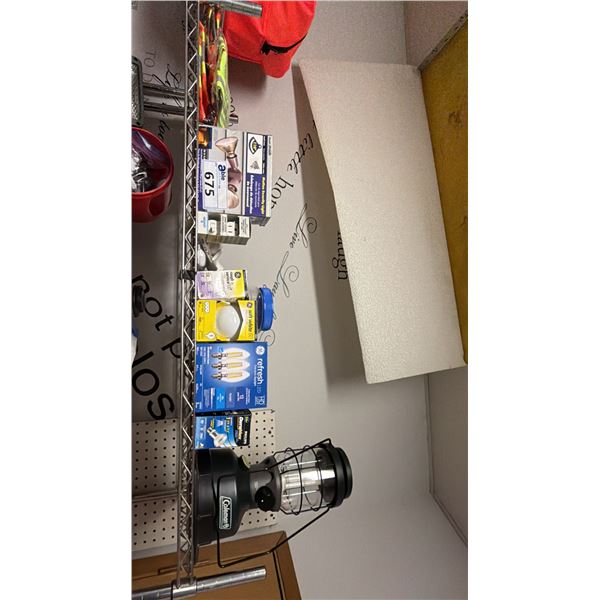 SHELF OF ASSORTED LIGHTBULBS, REFLECTOR VESTS & COLEMAN BATTERY POWERED LANTERN