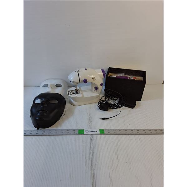 Assorted- Masks, Craft Box, Small Sewing Machine (Powers On,As Is)