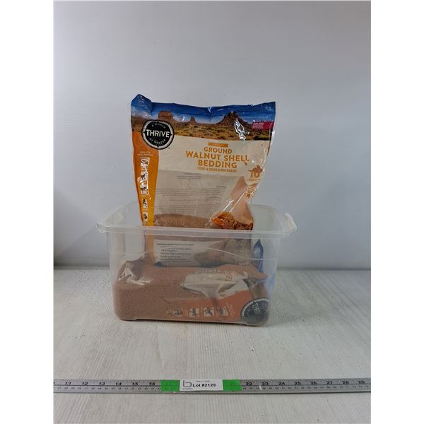 (2) Bags of Ground Walnut Shell Bedding ( partially full), Storage Bin With Lid ( cannot ship)