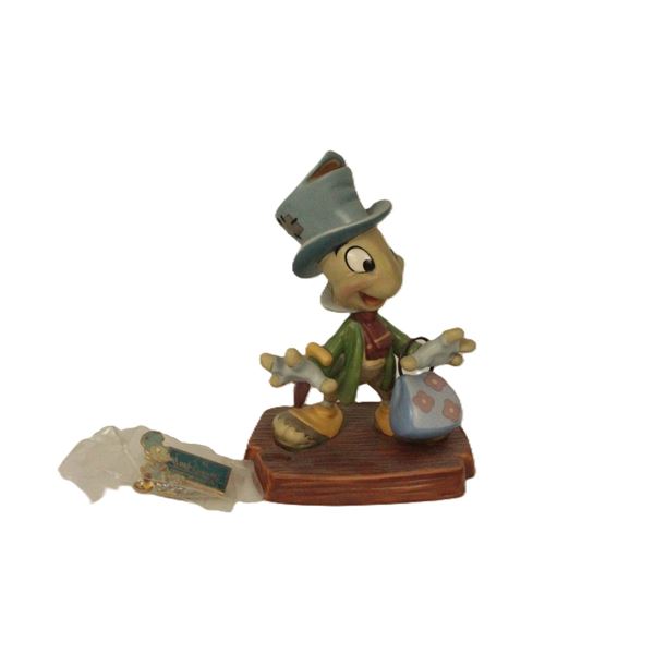 A WDCC 10th Anniversary Jiminy Cricket Figurine and Matching Pin.