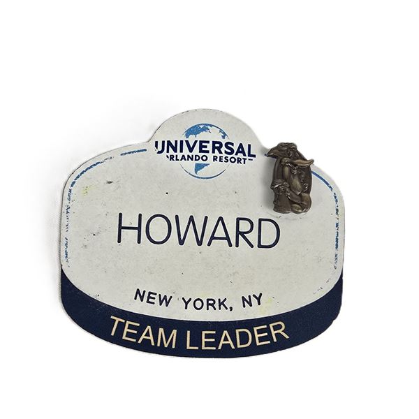 A Universal Studios Team Leader Badge With Retired Woody Woodpecker 1 Year Anniversary Pin.