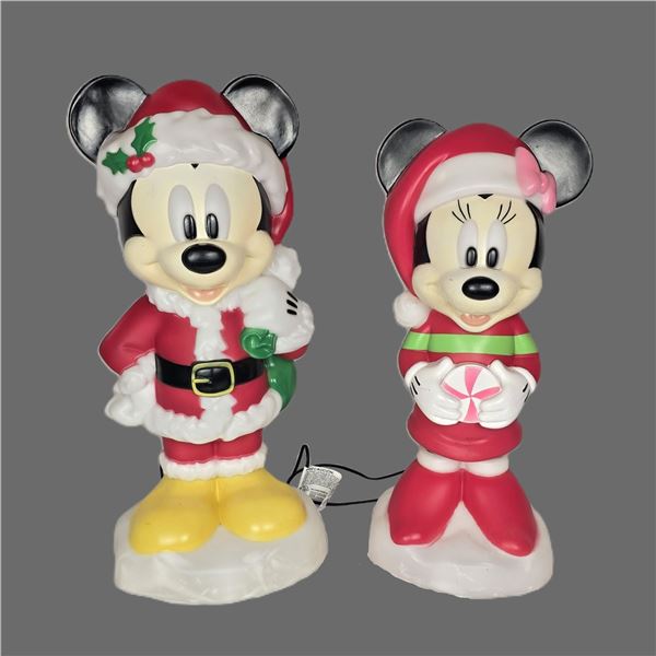 A Mickey and Minnie Mouse Light-up Mr. and Mrs. Claus Blowmold set.