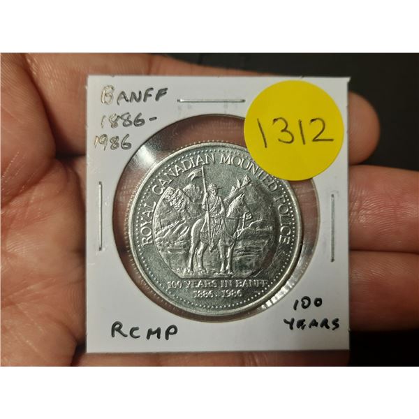1886 – 1986 Banff Trade Dollar commemorating 100 years of the RCMP in Banff. Unc.