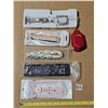 Image 1 : unused watch straps, key chain, money clip and universal remote