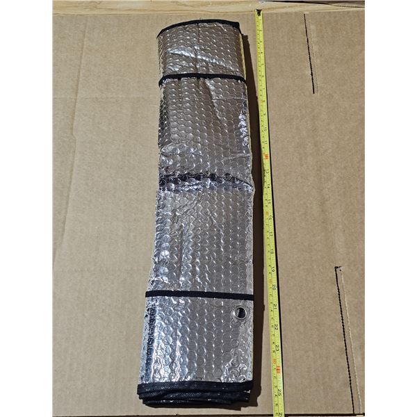 Unused windshield protective and sun visor shield