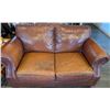 Image 1 : Brown Leather Loveseat with rivets - wear on one cushion seat and back top cushion. Cleans well, smo