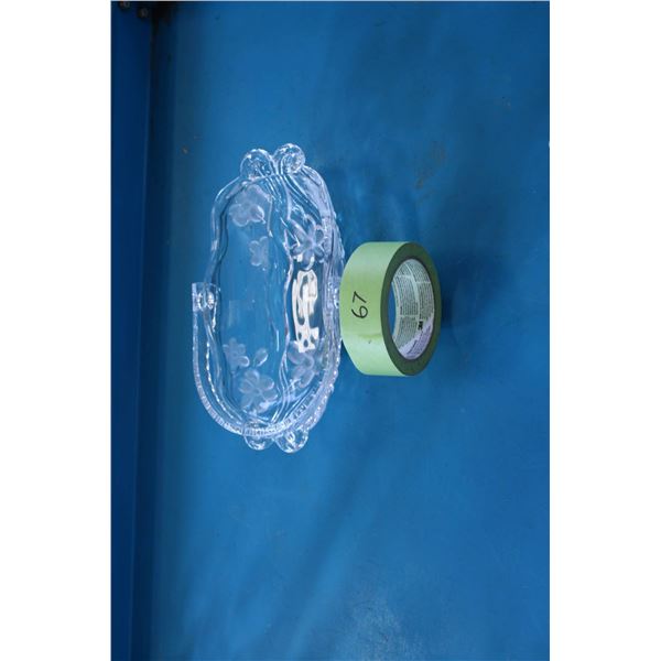 Clear glass dish featuring etched floral patterns and a wavy rim design. 