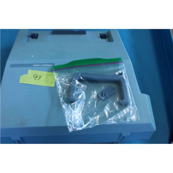 Smith-Corona Courier portable typewriter in a light blue casing with a matching hard carrying case. 