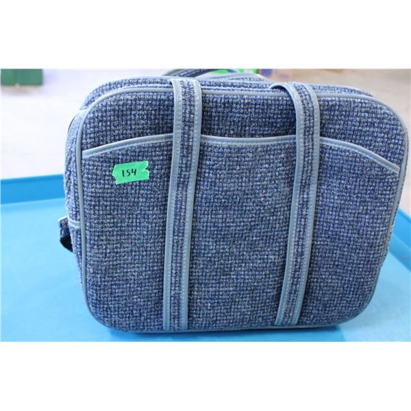 Blue tweed-style shoulder bag featuring multiple zippered compartments. 