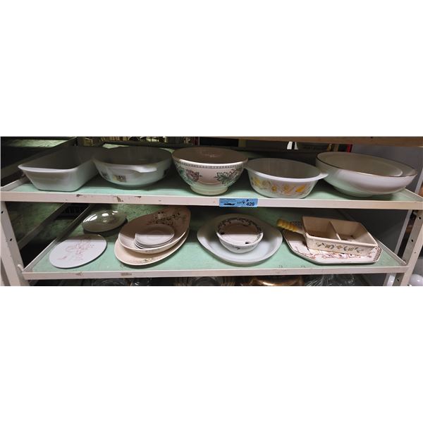 Two shelves of white vintage glassware