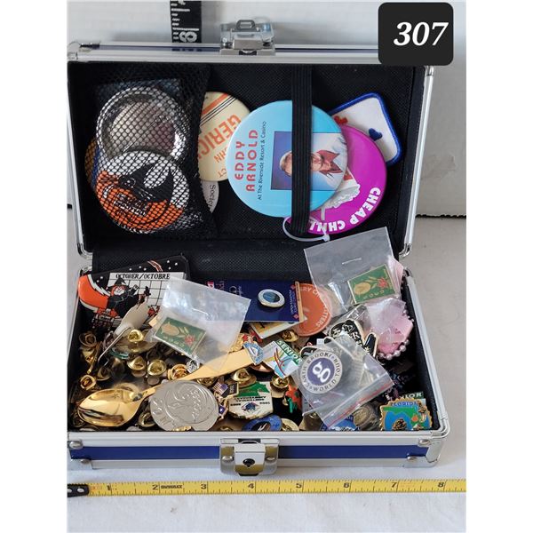 Small metal case filled with pins & pin back buttons.