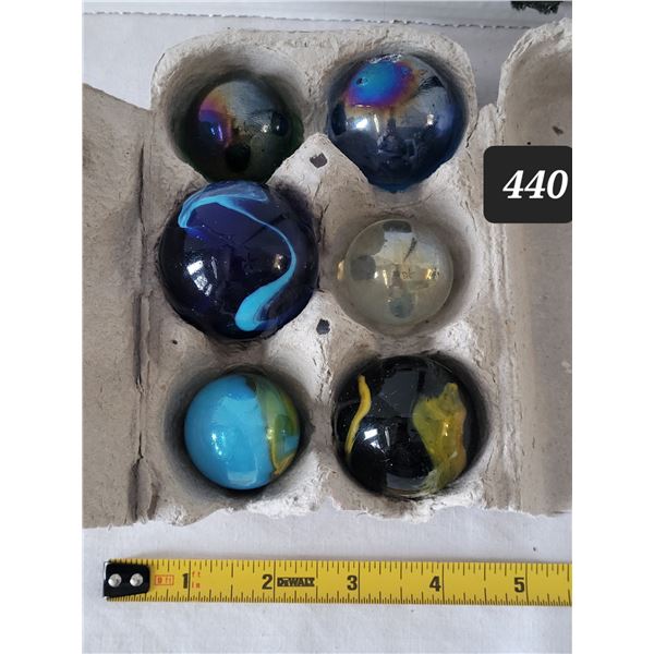 6 extra large marbles. Largest is Approx. 2” diameter.