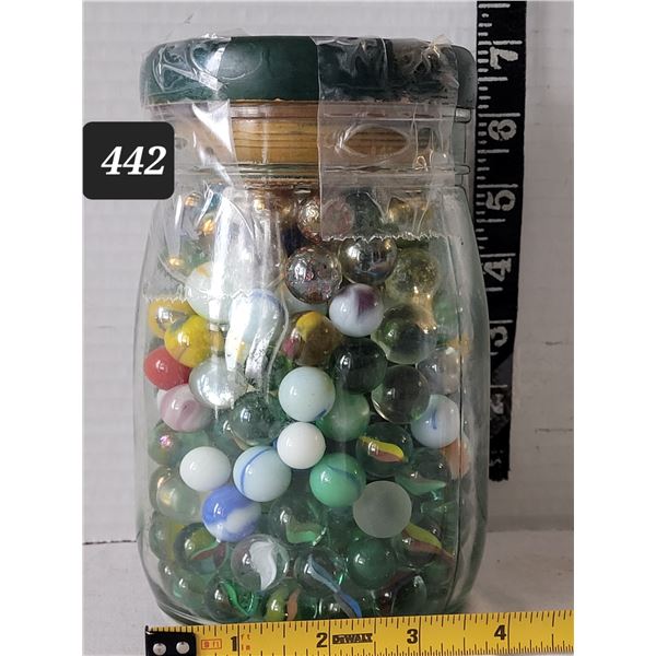 Large jar of assorted colors & size marbles.