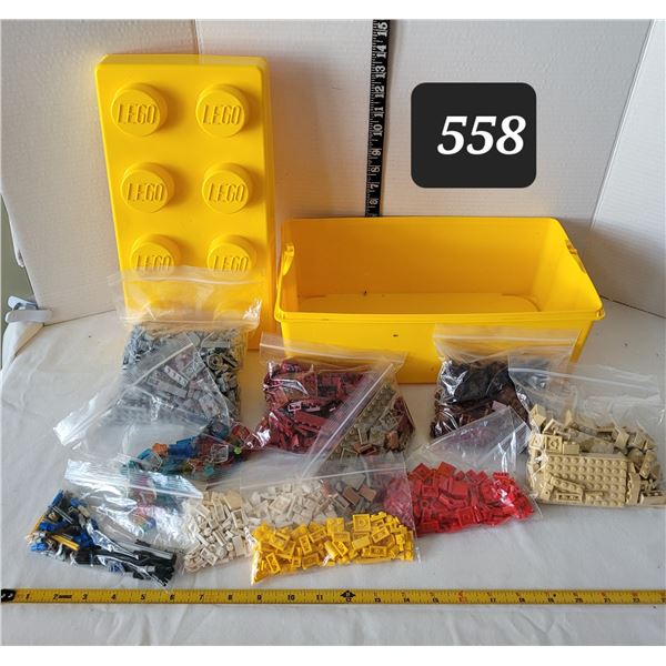 Lego storage brick containing bags of coloured lego bricks & specialty pieces.