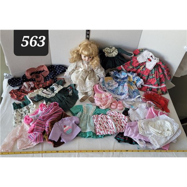 Vintage porcelain doll with many clothes.