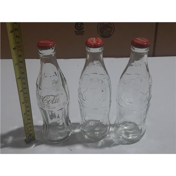 (3) Coca Cola Empty Bottles.