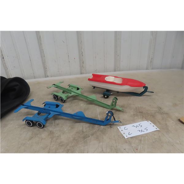 Three Boat Trailers Pressed Metal, Two Tandem and One Single Axle With One Plastic Boat Marked Budd