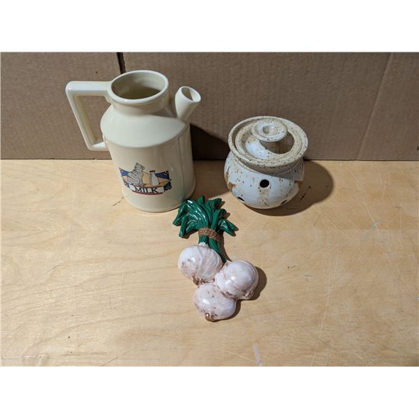 Glass pitcher with picture of a cat on it, garlic container and garlic wall hanger. All excellent co