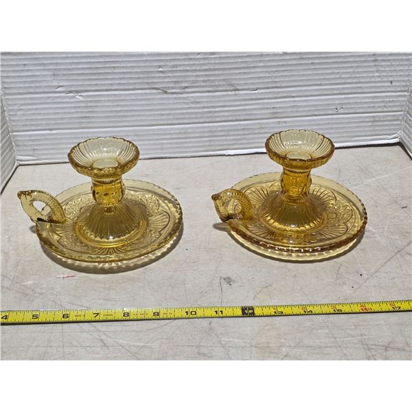 2 yellow glass candle stick holders
