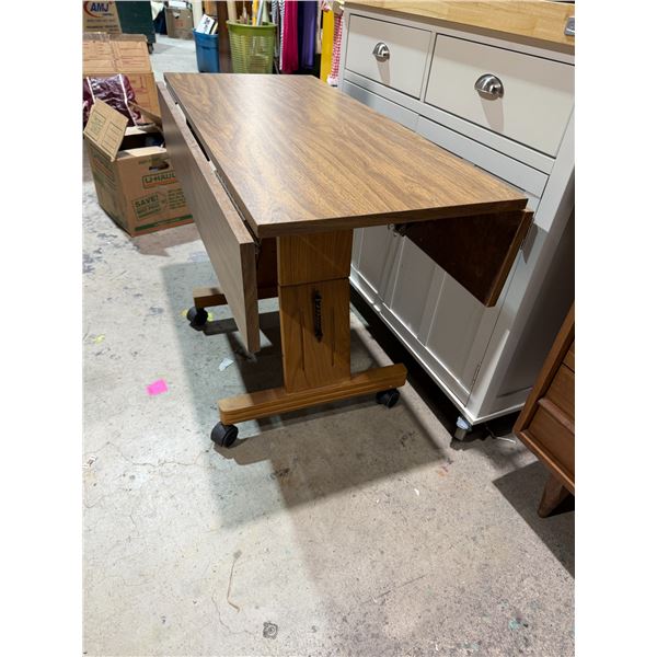 Rolling height adjustable table turns to Coffee Table with Drop sides measures coordination wall