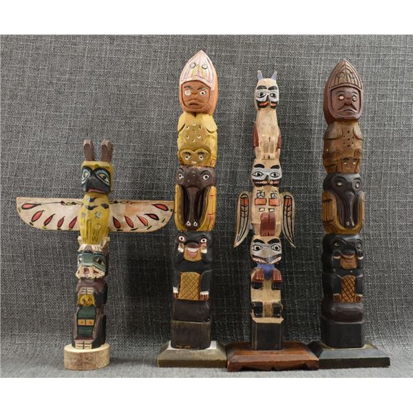 FOUR DECORATIVE TOTEM POLES