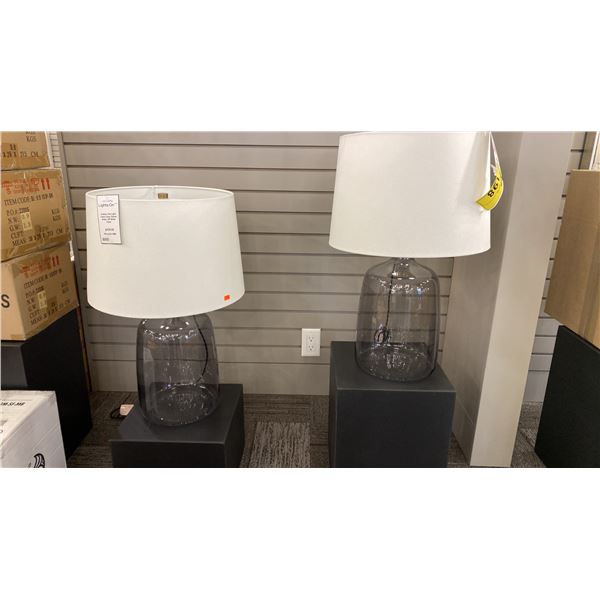 PAIR OF ARTESIA TABLE LAMPS. PATINA BRASS SMOKED GLASS AND OFF WHITE SHADES. RETAIL $1800