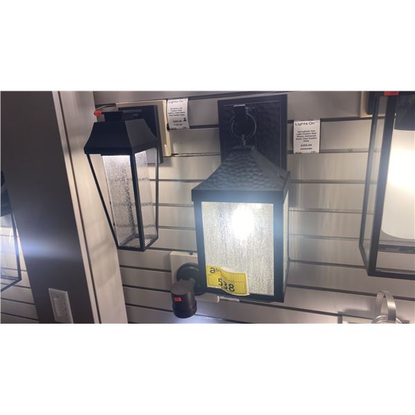 GROUP OF 7 SPRINGFIELD OUTDOOR WALL MOUNT DISTRESSED BLACK, CLEAR SEEDED GLASS FIXTURES.