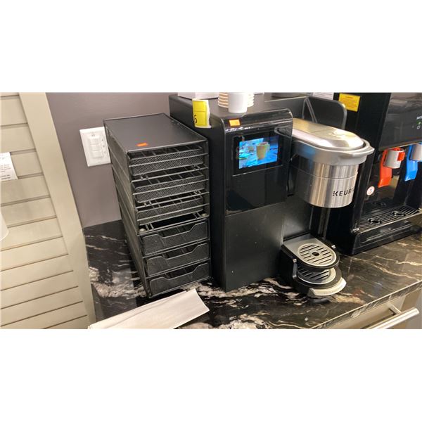 COMMERCIAL KEURIG MACHINE WITH COFFEE STORAGE RACK. PLUMBED IN (NO WATER TANK) PLUS METAL GARBAGE