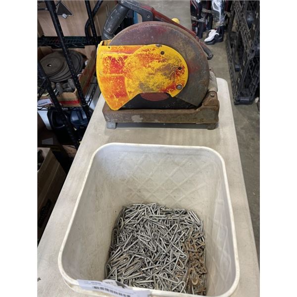 CHOP SAW AND BUCKET OF PEG HOOKS