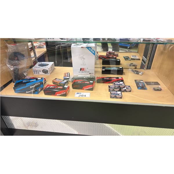 CONTENTS OF SHOWCASE INCLUDING; GENS ACO 2200 111V BATTERIES, TRAXXAS POWER CELL BATTERIES, SKYRC
