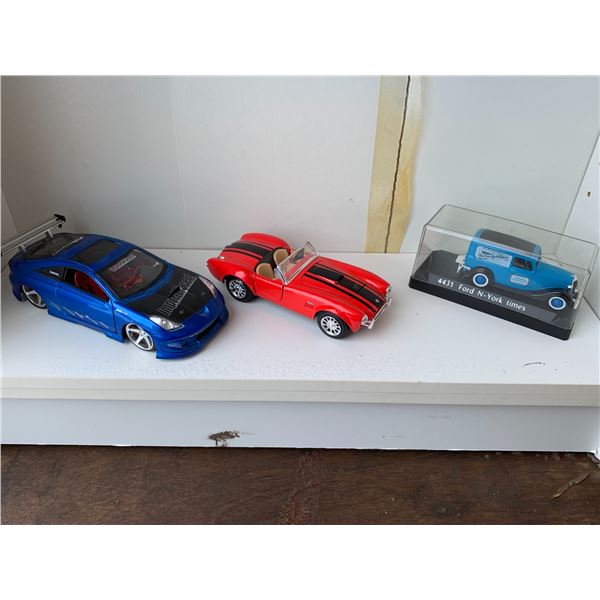 3- Toy sports vehicles (Blue race car, red convertible & 4431 Ford N-York times vehicle)