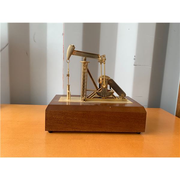 Ornamental brass oil pump jack music box, works