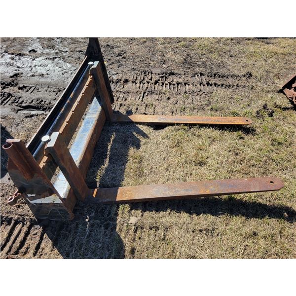 48 inch Bobcat forks, one fork appears bent